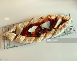 DOHA, QATAR - NOVEMBER 16: A Beef Pepperoni and Olive Turkish Pide with Oregano and Parmesan at Mosaic, the speciality nine-kitchen restaurant at the Mandarin Oriental, Doha on November 16, 2019 in Doha, Qatar. (Photo by Rubina A. Khan/Getty Images)