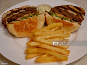 DOHA, QATAR - NOVEMBER 17: A Wagyu Burger with Veal Bacon and Fries at the outdoor terrace at Izu, a Mediterranean cuisine restaurant named after its Nigerian chef, Izu Ani, facing the Barahat Msheireb Town Square at the Mandarin Oriental, Doha on November 17, 2019 in Doha, Qatar. (Photo by Rubina A. Khan/Getty Images)